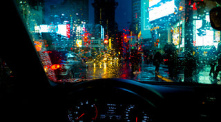 Image of Dundas Square Taken through a wet windshield inside of a car at night