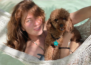 Girl with a dog on a hammock